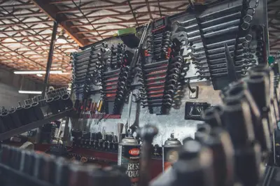 A workshop wall hung with rows of organized wrenches and hand tools