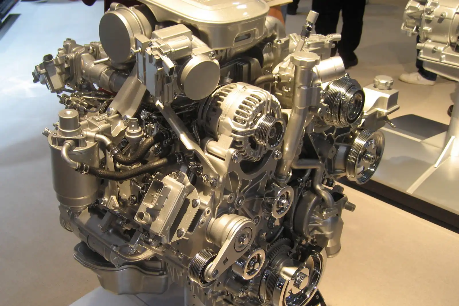 A heavy-duty diesel V8 out of the truck, showing the injection lines and belt drive Floorjack Auto Repair works on for Phoenix diesel owners